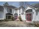 Charming two-story home with red front doors, white stucco, black trim, and stone accents at 1458 Sweet Bottom Cir, Marietta, GA 30064