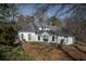 Picturesque home exterior features custom stonework, an arched iron gate, and manicured landscaping at 1458 Sweet Bottom Cir, Marietta, GA 30064