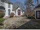 Exterior view of the stucco home with red doors, black trim, and a stone driveway at 1458 Sweet Bottom Cir, Marietta, GA 30064