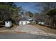 Street view of the home with unique architectural features, mature trees and circular driveway at 1458 Sweet Bottom Cir, Marietta, GA 30064