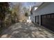 Home exterior with dark garage doors, side yard, and plenty of parking at 1458 Sweet Bottom Cir, Marietta, GA 30064