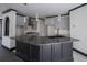 A close-up of kitchen island with granite countertop, undermount sink, and dark wood cabinets at 1458 Sweet Bottom Cir, Marietta, GA 30064