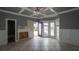 Living room with a coffered ceiling and an exposed area where a fireplace was removed, leading to the backyard at 1458 Sweet Bottom Cir, Marietta, GA 30064