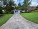 Inviting single-story home with a blue driveway, mature trees, and classic curb appeal at 2323 Valleyside Dr, Decatur, GA 30032