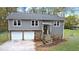 Charming home featuring a stone foundation, attached two-car garage, and inviting front entrance at 378 Cole Sw Dr, Lilburn, GA 30047
