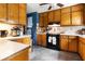 Kitchen featuring wood cabinetry, white countertops, and modern appliances at 378 Cole Sw Dr, Lilburn, GA 30047