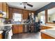 Kitchen showcasing stainless steel appliances, wooden cabinetry, and a sink overlooking the yard at 378 Cole Sw Dr, Lilburn, GA 30047