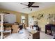 Bright living room with tile flooring, ceiling fan, and space for pet accessories at 378 Cole Sw Dr, Lilburn, GA 30047