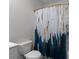 Stylish bathroom featuring a blue and white patterned shower curtain adding a touch of color and artistry to the space at 4171 Dean Grove Way, Loganville, GA 30052