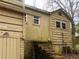 Exterior view with a brick foundation, siding and aging details at 339 Kelly Mill Rd, Cumming, GA 30040