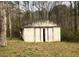 Shows the cinder block outbuilding featuring sliding doors and a rustic, aged exterior at 339 Kelly Mill Rd, Cumming, GA 30040