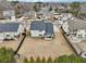 An aerial view of the back of a two-story house with a lawn and a fence surrounding the property at 504 Taymack Farm Ct, Woodstock, GA 30188