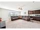 Finished basement with a wet bar, carpet, and comfortable seating area at 504 Taymack Farm Ct, Woodstock, GA 30188