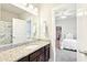 Bathroom with dark wood vanity, granite countertop, decorative mirror, and shower/tub combo at 504 Taymack Farm Ct, Woodstock, GA 30188