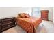 Bedroom with matching dressers on either side of bed with patterned bedding at 504 Taymack Farm Ct, Woodstock, GA 30188