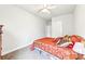 Cozy bedroom featuring a bed with decorative pillows, a ceiling fan, and neutral walls at 504 Taymack Farm Ct, Woodstock, GA 30188