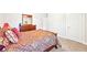 A comfortably decorated bedroom featuring a decorative dresser and soft carpet at 504 Taymack Farm Ct, Woodstock, GA 30188
