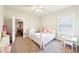 Bright bedroom with a ceiling fan, a closet, and a window that lets in lots of natural light at 504 Taymack Farm Ct, Woodstock, GA 30188