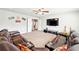Large bonus room featuring a TV and surround sound system with a sectional sofa at 504 Taymack Farm Ct, Woodstock, GA 30188