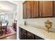 Butler's pantry features granite countertops, dark wood cabinets, and access to the dining room at 504 Taymack Farm Ct, Woodstock, GA 30188
