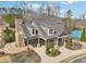 Community clubhouse with outdoor fireplace, covered seating area, and tennis courts in the background at 504 Taymack Farm Ct, Woodstock, GA 30188