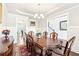 Elegant dining room with coffered ceilings, wainscoting, chandelier, and hardwood floors at 504 Taymack Farm Ct, Woodstock, GA 30188
