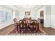 Formal dining room featuring wainscoting, elegant lighting, and a decorative rug at 504 Taymack Farm Ct, Woodstock, GA 30188