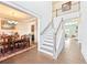 Inviting foyer with staircase provides access to the dining room and hallway with hardwood floors at 504 Taymack Farm Ct, Woodstock, GA 30188