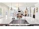 Bright kitchen island with a stainless steel sink and granite countertop, open to the living room at 504 Taymack Farm Ct, Woodstock, GA 30188