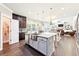 Open kitchen featuring granite countertops, stainless steel appliances, and a breakfast bar island at 504 Taymack Farm Ct, Woodstock, GA 30188