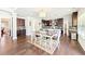 Open concept kitchen and dining area featuring dark cabinets, stainless steel appliances and hardwood floors at 504 Taymack Farm Ct, Woodstock, GA 30188