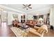Spacious living room with hardwood floors, comfortable seating, and an open layout connecting to the kitchen at 504 Taymack Farm Ct, Woodstock, GA 30188