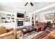 Cozy living room with fireplace, built-in shelving, and comfortable seating at 504 Taymack Farm Ct, Woodstock, GA 30188