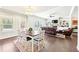 Bright living space includes a dining area and a cozy living room with a fireplace at 504 Taymack Farm Ct, Woodstock, GA 30188