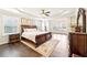 Spacious main bedroom with tray ceiling, dark hardwood floors and natural light from large windows at 504 Taymack Farm Ct, Woodstock, GA 30188