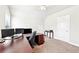 Bright home office space featuring a large desk, multiple monitors, and neutral walls at 504 Taymack Farm Ct, Woodstock, GA 30188