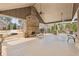 Spacious covered patio with a stone fireplace, offering a cozy outdoor living area with views of the property at 504 Taymack Farm Ct, Woodstock, GA 30188
