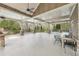 Expansive covered patio with ceiling fans and stone columns, perfect for relaxing or entertaining outdoors at 504 Taymack Farm Ct, Woodstock, GA 30188