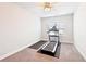 Workout room features a treadmill, neutral carpeting, and plenty of natural light at 504 Taymack Farm Ct, Woodstock, GA 30188