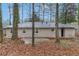 The backyard features a patio area, surrounded by mature trees that offer shade and privacy at 1883 Windsor Sw Dr, Atlanta, GA 30311
