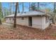 This home boasts a gray brick exterior, complemented by a well-maintained yard, nestled among tall trees at 1883 Windsor Sw Dr, Atlanta, GA 30311