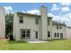 Well-maintained backyard features lush green lawn and neutral-toned exterior with a door and chimney at 4678 Ravenwood Loop, Union City, GA 30291