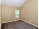 Neutral bedroom with plush carpeting and natural light from a single window at 4678 Ravenwood Loop, Union City, GA 30291