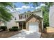 Two-story home featuring red shutters, brick accent, single car garage, and well-maintained landscaping at 4678 Ravenwood Loop, Union City, GA 30291