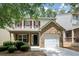 Charming home with red shutters, covered porch, brick detail, and a single car garage at 4678 Ravenwood Loop, Union City, GA 30291