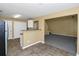 Cozy kitchen with granite countertops adjacent to open-concept living area with staircase at 4678 Ravenwood Loop, Union City, GA 30291