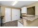 Kitchen with breakfast bar featuring granite countertop, white cabinets, pantry, and tile floors at 4678 Ravenwood Loop, Union City, GA 30291