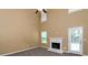 Bright living room featuring a fireplace, ceiling fan, and ample natural light at 4678 Ravenwood Loop, Union City, GA 30291