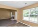 Cozy living room featuring a fireplace, window, and neutral walls at 4678 Ravenwood Loop, Union City, GA 30291