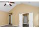 Airy main bedroom with high ceiling, fan, and adjacent bathroom at 4678 Ravenwood Loop, Union City, GA 30291